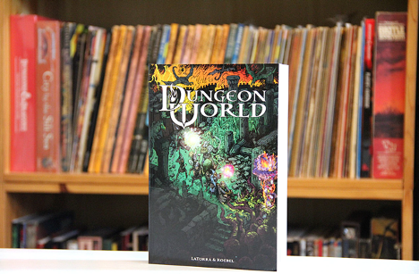 Dungeon World cover, in front of bookcase