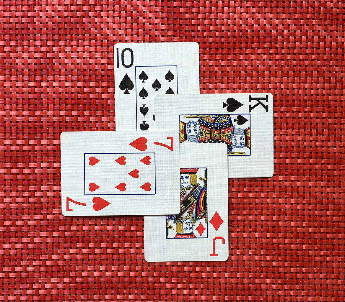 Four overlapping playing cards