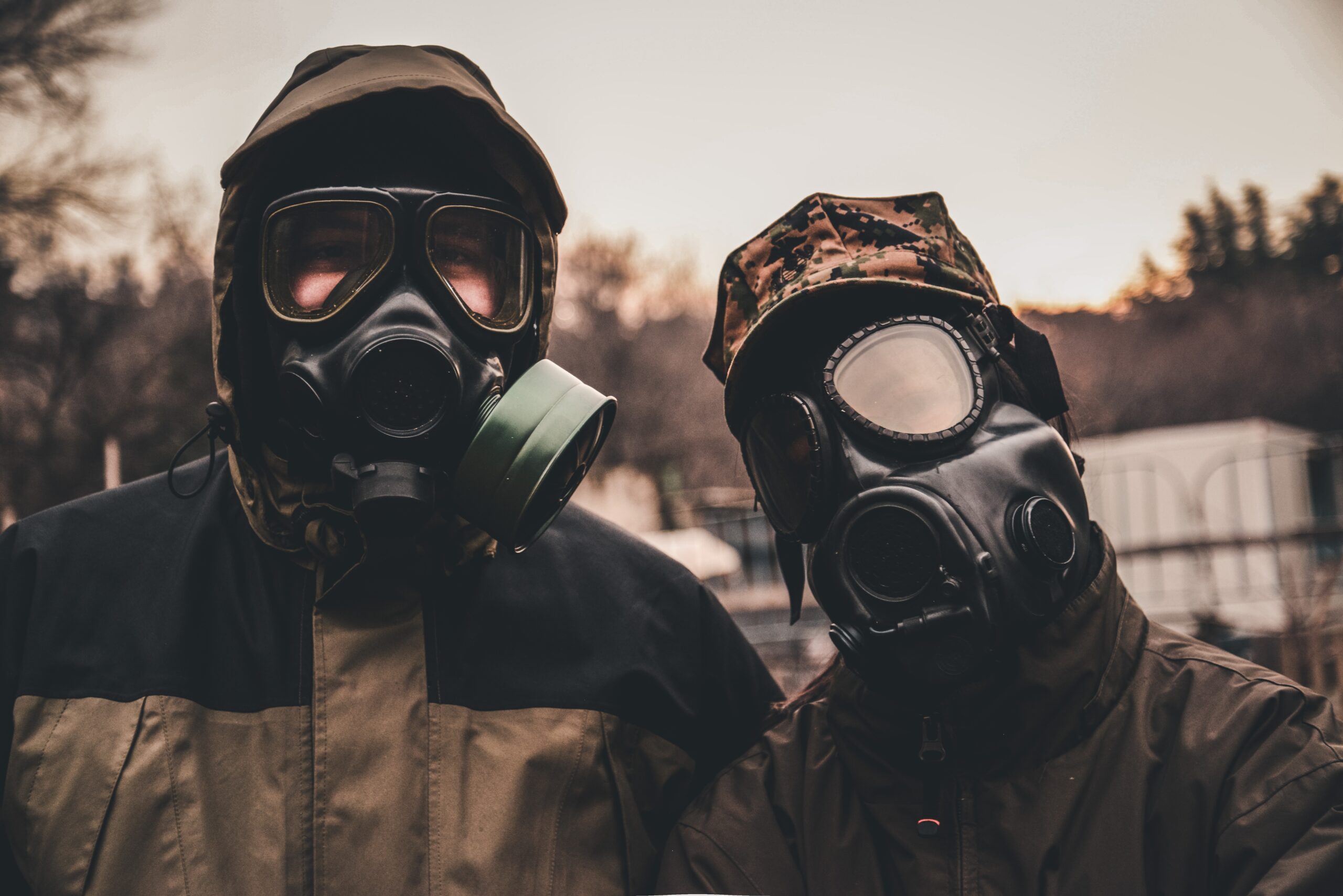 2 people wearing gas masks