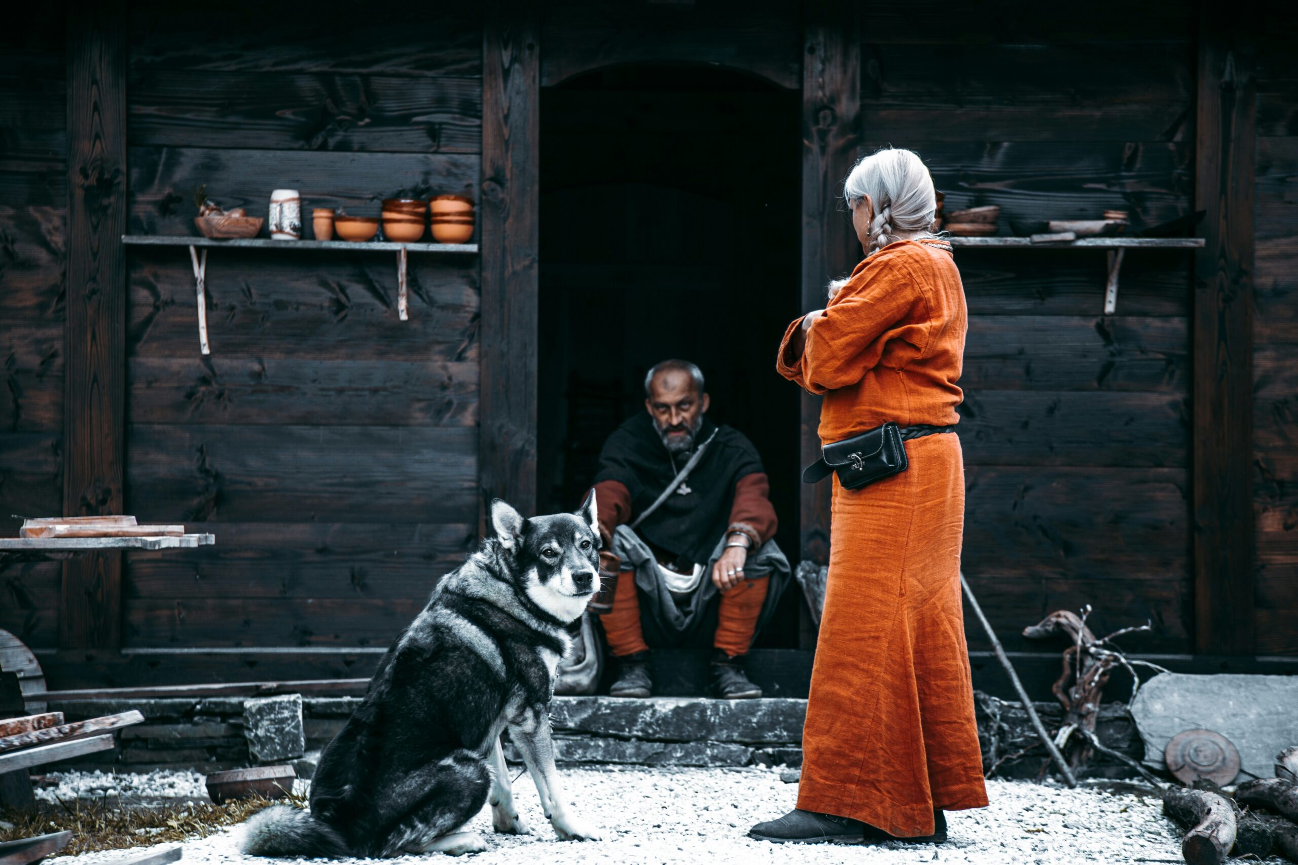 man, woman, wolf inside a Viking village in Gudvangen, Norway