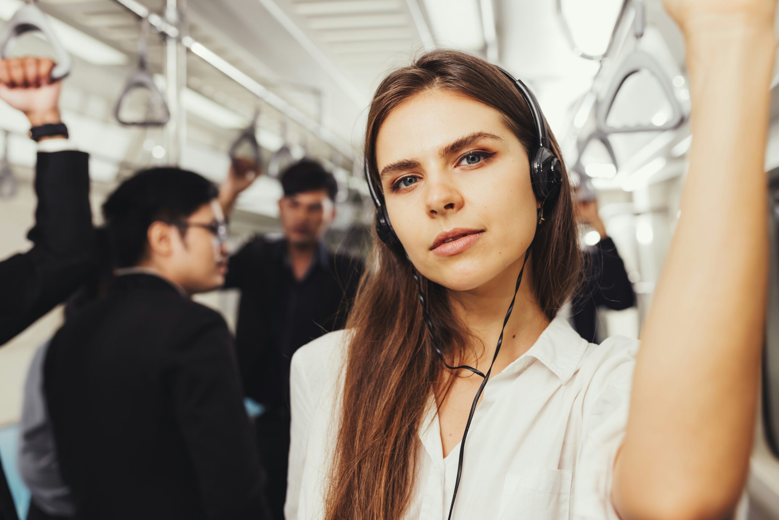 woman wearing earphones on train