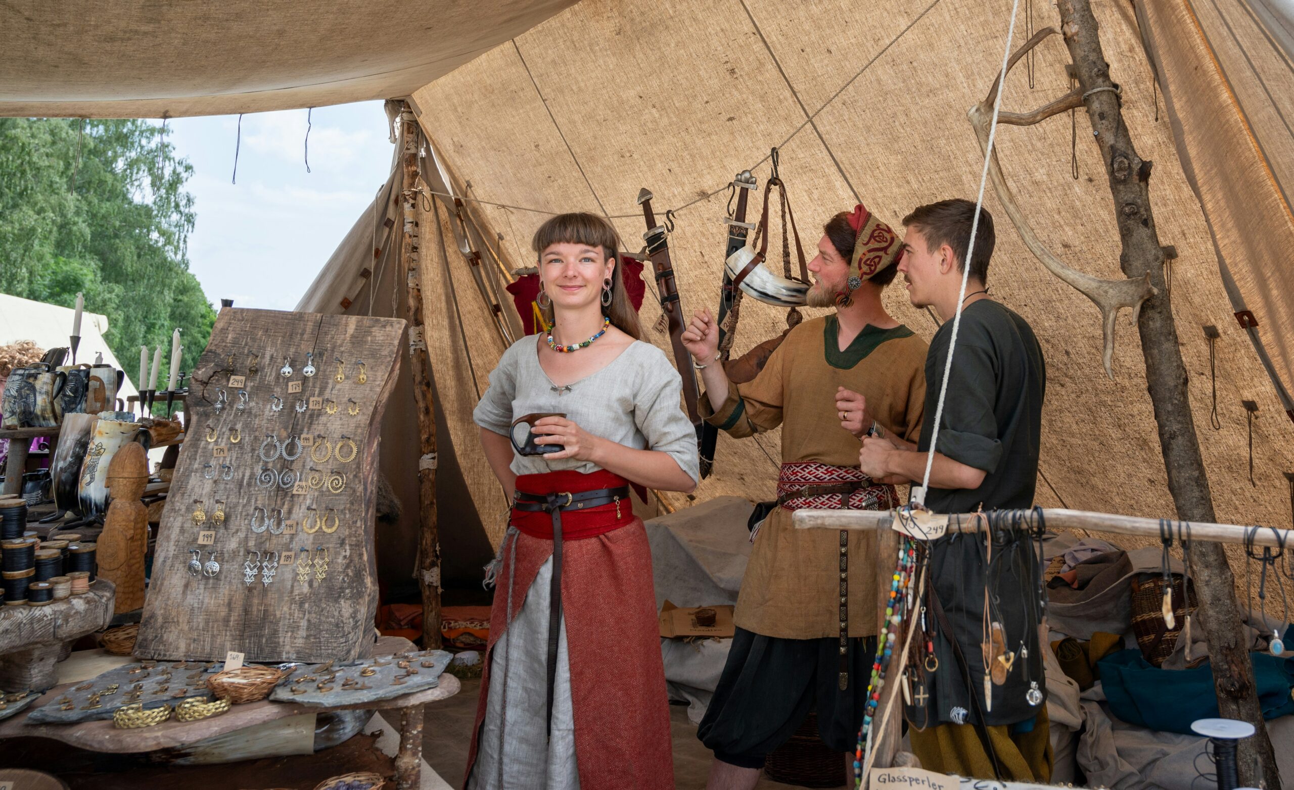 Three period-appropriate dressed customers at the Nordlysviking viking market at Borre, Norway