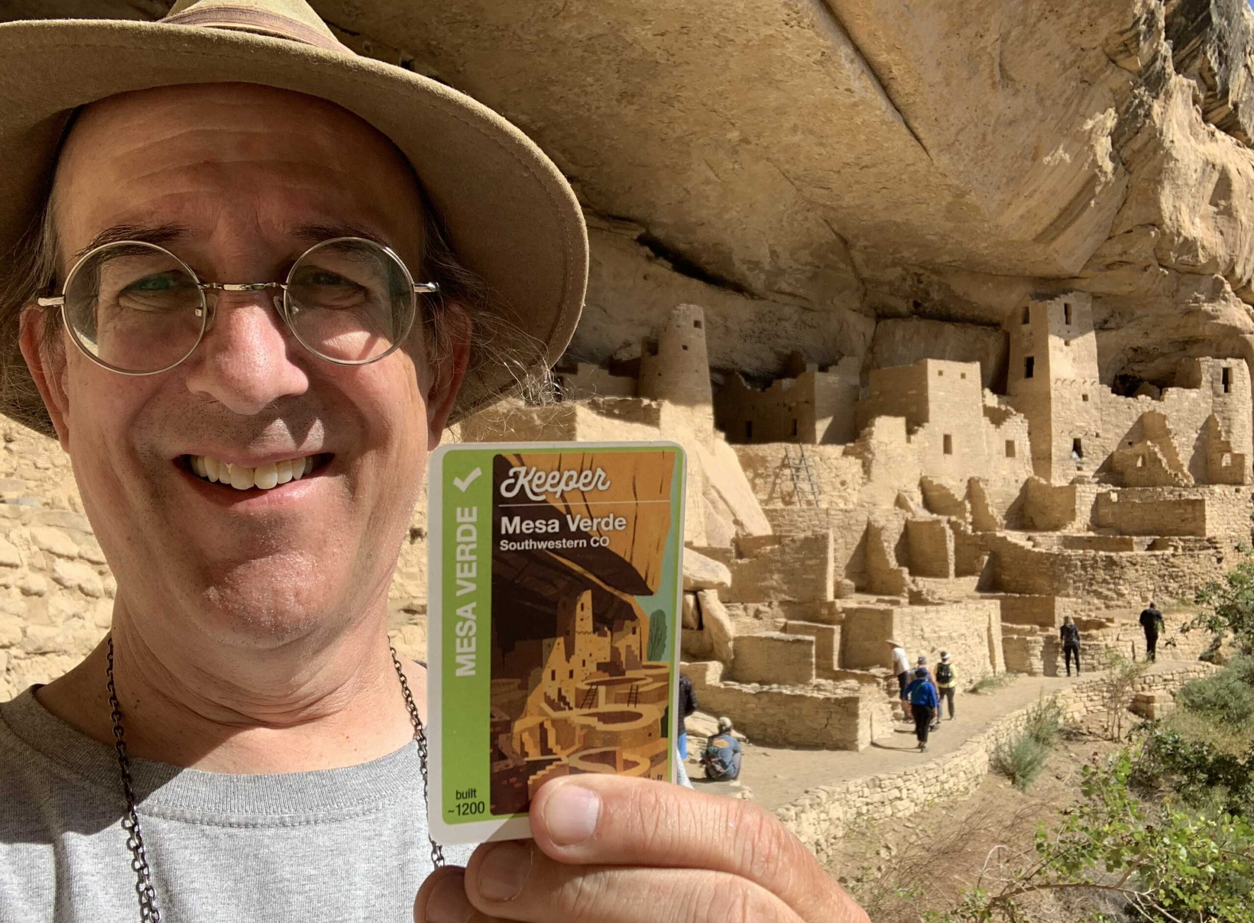 Andy Looney at Mesa Verde, holding the Mesa Verde card from Across America Fluxx